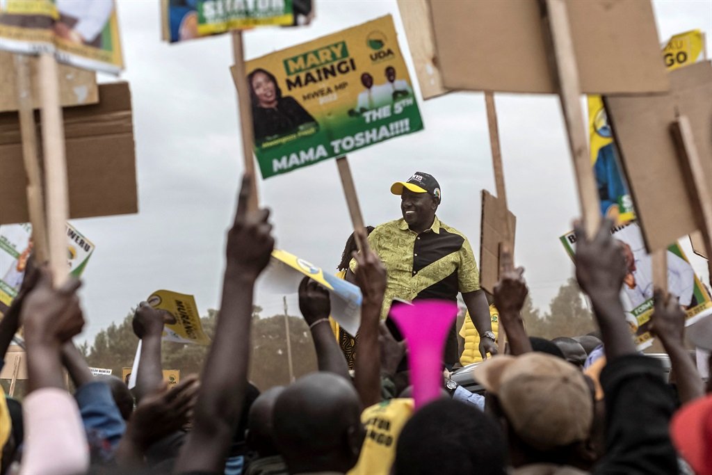 Kenya Kwanza political party coalition flag bearer, William Ruto arrives to the jubilation of placard carrying supporters during a campaign rally in Mwea constituency, Kirinyaga county in Kenya's central highlands on July 27, 2022. 